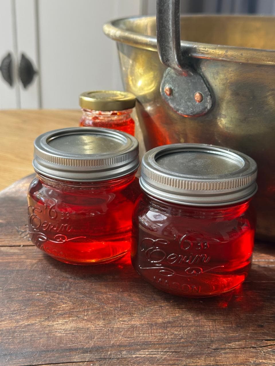 Quince jelly on a wooden board and next to a copper bucket