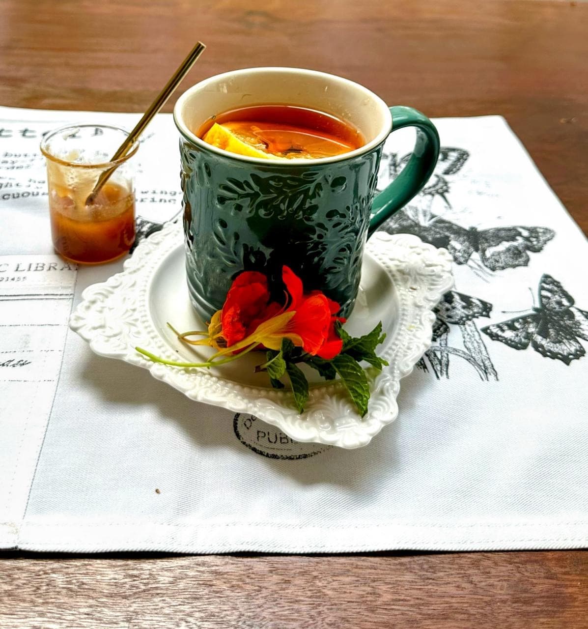 green mug with herbal tea on a white tea towel